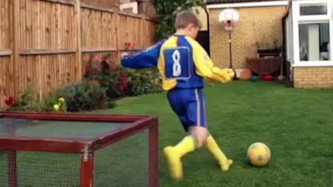 A boy kicking a ball.