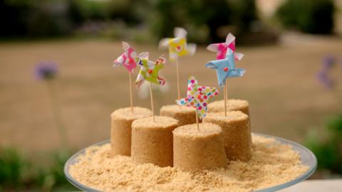 A cheesecake made to look like a sandcastle.