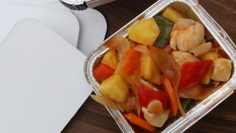 A container of sweet and sour chicken.