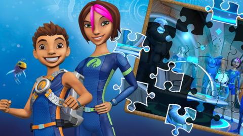 A boy and girl wearing blue wetsuits stand in front of an incomplete jigsaw puzzle, Ant and Fontaine from The Deep.