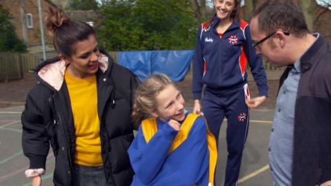 Maddie in her netball kit stood between Lauren and Joe.