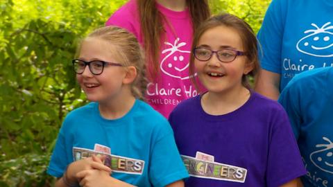 Two young girls looking excited.