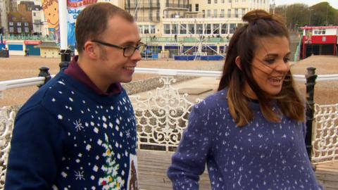 Joe and Lauren wearing Christmas jumpers.