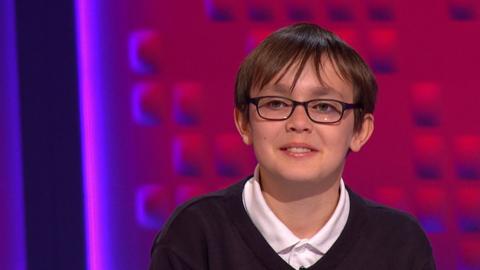 A boy wearing glasses in the Top Class studio.