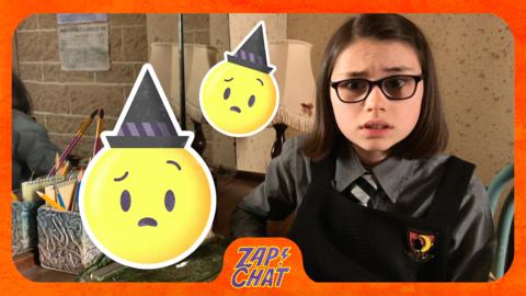 A young witch (Clarice) looks anxious next to a witch emoji.