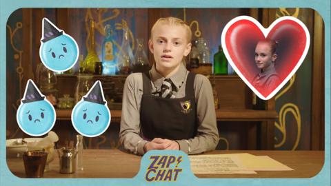 A young witch smiles to the camera with an emoji heart and emoji sad faces next to her.