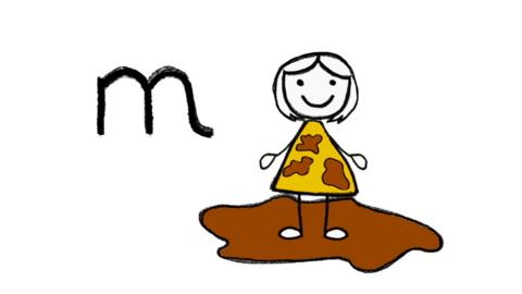 A girl standing in mud and the letter m