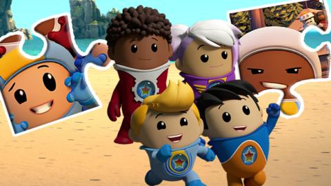 The Go jetters are on a beach, there are two jigsaw pieces next to them with their faces on it.