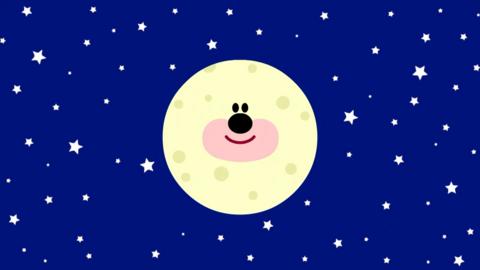 Dark blue sky with stars and a large moon with a face.