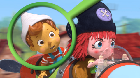 Pinocchio and Freeda are flying a plane. There is a large green magnifying glass over Pinocchio's face