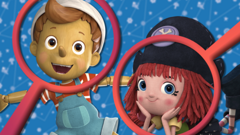 Pinocchio and Freeda smile towards the camera. The background is a blurred blue starry sky and there are two red magnifying glasses covering both of the characters faces