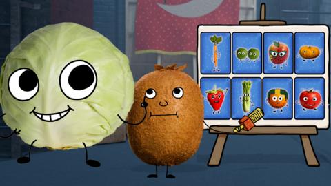 Cabbage and Kiwi are looking at a board with cards on it, the cards each have a fruit or vegetable on them.