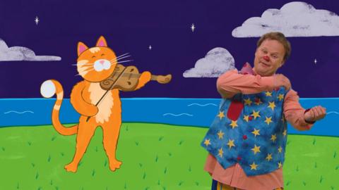 Mr Tumble and a cat playing a fiddle