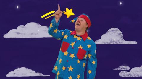 Mr Tumble looking up at a star flying through the sky