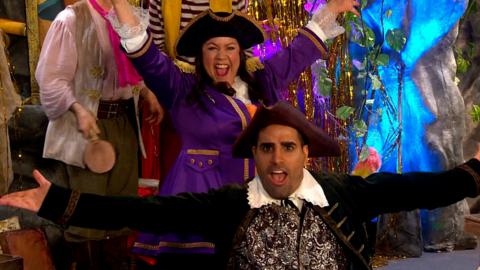 Captain Captain and Captain Twinkle toes have their arms stretched out in celebration.