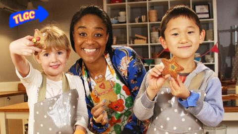 Joanna and two children holding gingerbread shapes