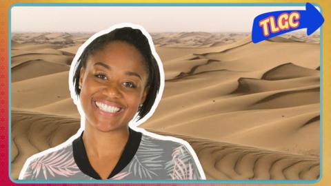 Joanna standing in front of sand dunes