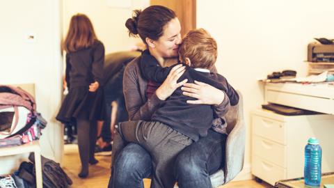 A boy cuddling his mum before school