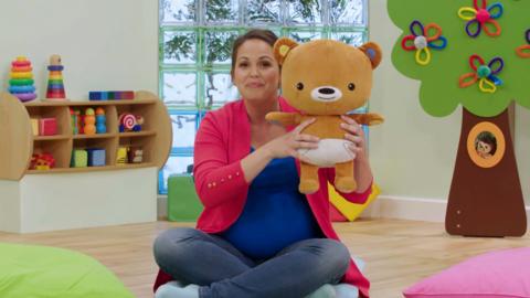 Giovanna Fletcher holding Baby Bear from CBeebies The Baby Club.