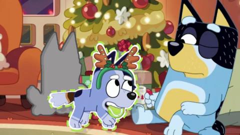 bandit a blue dog is sitting by a christmas tree, socks a young dog is wearing a deer headband carrying a ball in its mouth. It is a sticker on the image.