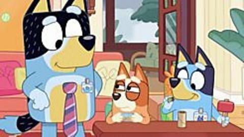 Bandit is wearing a tie, bingo and bluey are sitting at a table.