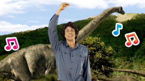 Andy in front of a Brachiosaurus