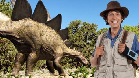 Andy next to a Stegosaurus.