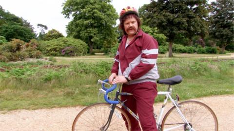 Keith Fitt standing with a bicycle.