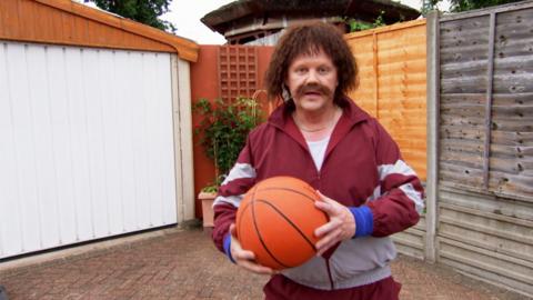 Keith Fitt holding a basketball.