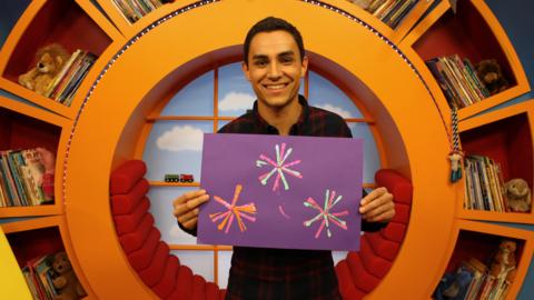 Ben holding his Diwali firework picture.