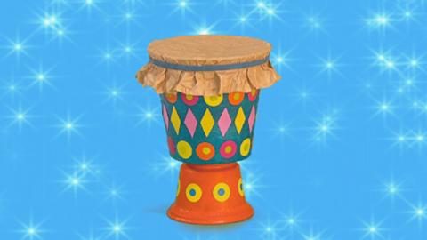 A bongo drum decorated with stickers.