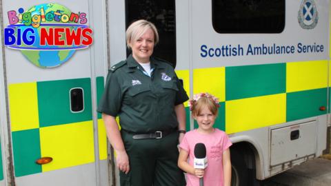 Grace and her mum Pamela stood in front of an ambulance with Scottish Ambulance Service on the side.