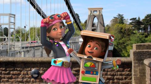 Bitz and Bob standing next to a big suspension bridge with cars driving over it.