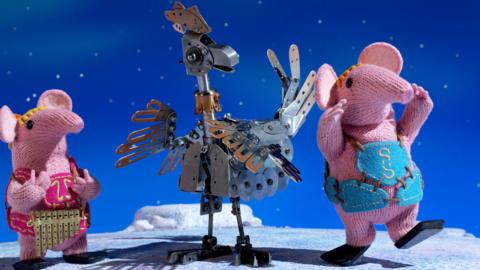 Tiny and Small Clanger from The Clangers dancing with the Iron Chicken.