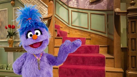 Phoebe from The Furchester Hotel in front of the stairs.