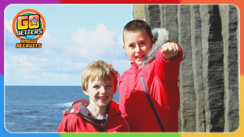 Go Jetters Radio Recruits Boyd and Finlay are standing by the sea on the Isle of Staffa