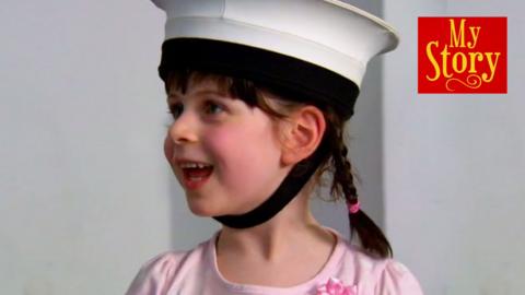 Emily smiling and wearing a sailor's hat, with the My Story logo.