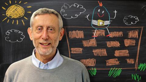 Michael Rosen from Poetry Playtime in front of a blackboard picture of Humpty Dumpty sitting on a wall.