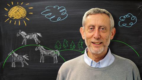 Michael Rosen from Poetry Playtime in front of a blackboard picture of white horses.