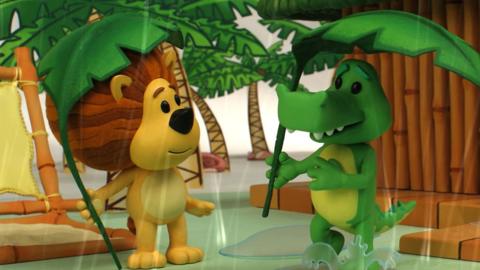 Raa Raa the Noisy Lion and Crocky sheltering from the jungle rain underneath a pair of large palm leaves.