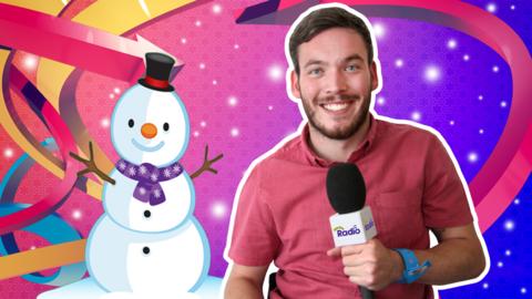 Martin from The Let's Go Radio Club smiling and holding a CBeebies Radio microphone next to a snowman