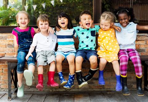 Six children sitting outside together