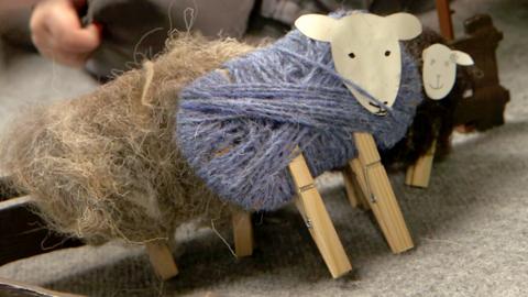 A sheep made from pegs and wool