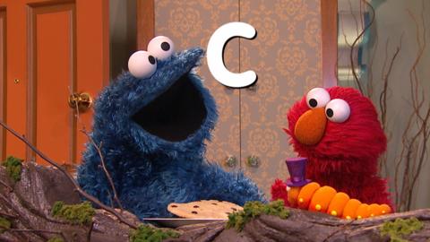 Cookie Monster and Elmo with the letter C.