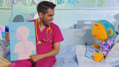 Dr Ranj holding a diagram of a body