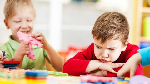 Two boys playing at a table