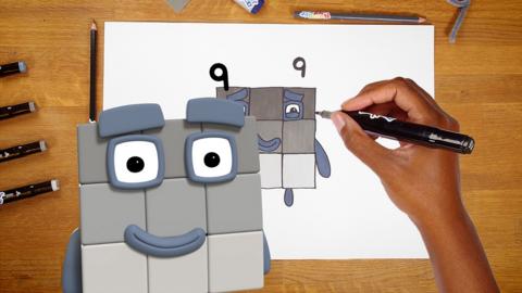 Illustration of numberblock nine, next to a handdrawn version of it and a hand holding a pen.