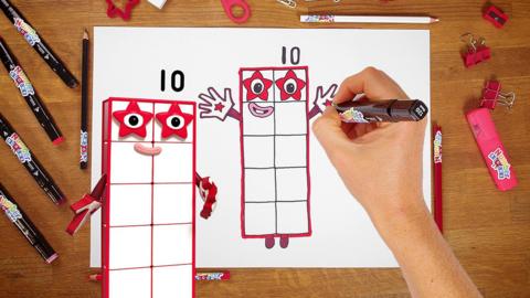 Numberblock ten is handdrawn, pictured next to a hand holding a pen and an illustration of numberblock ten.