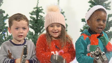 Kids singing Christmas songs.