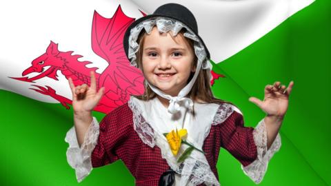 Welsh flag with a young girl standing in front of it.